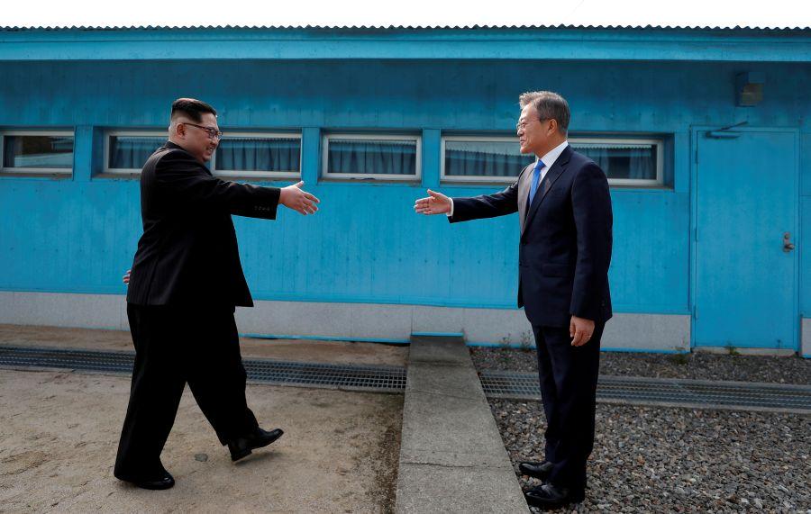 South Korean President Moon Jae-in and North Korean leader Kim Jong Un shake hands at the truce village of Panmunjom