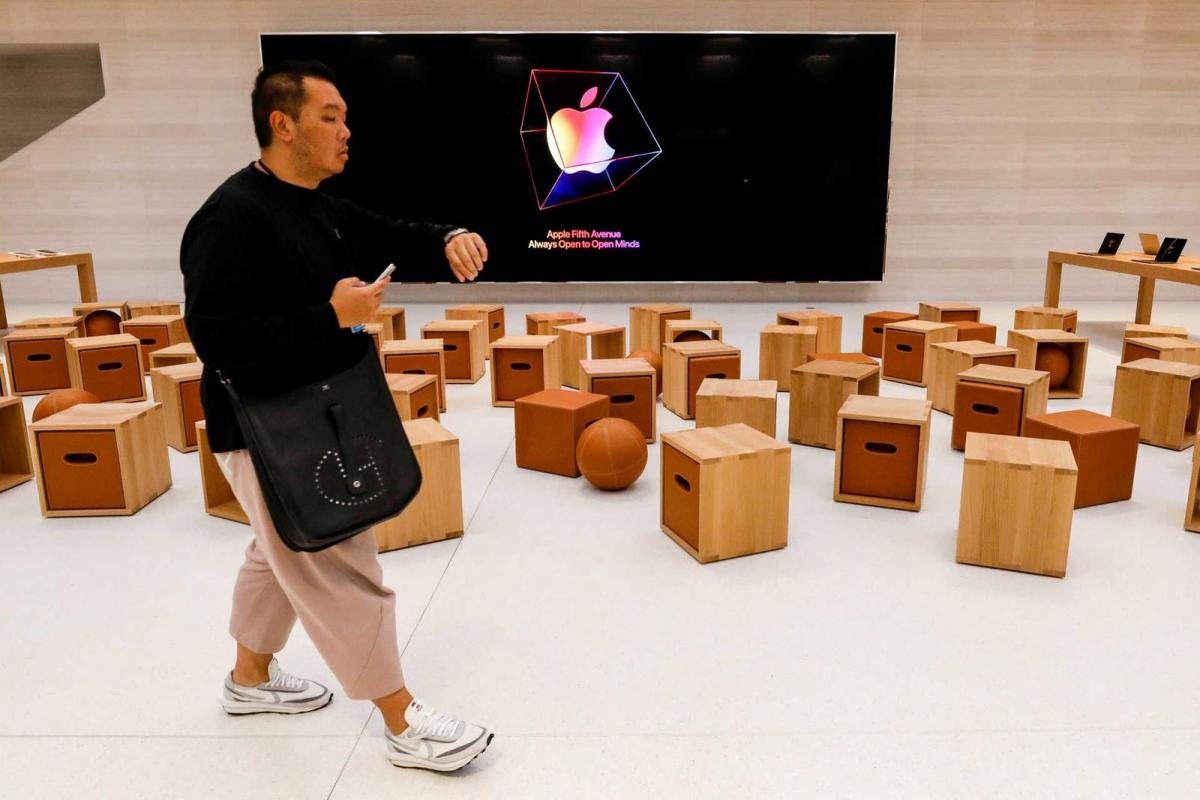 A guest attends the preview of the redesigned and reimagined Apple Fifth Avenue store in New York